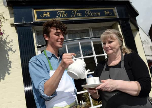 Jospeh Ashley serves tea to Joyce Brightmore to promote their free cup of tea when a cake is purchased at The Tea Room on Epworthâ¬"s High Street