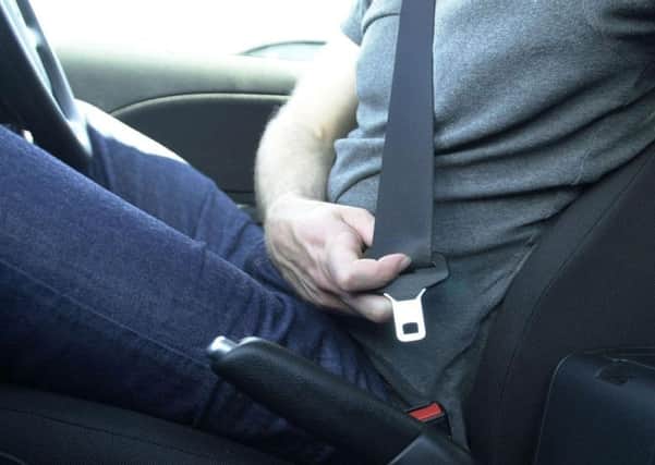 File photo dated 24/08/03 of a driver using his seatbelt. PRESS ASSOCIATION Photo. Issue date: Friday August 31, 2008. Hunchbacks, dwarves and even "irrational objections" from the elderly helped delay the introduction of compulsory seatbelts by more than 10 years, secret documents reveal today. See PA story RECORDS Belt. Photo credit should read: Haydn West/PA Wire