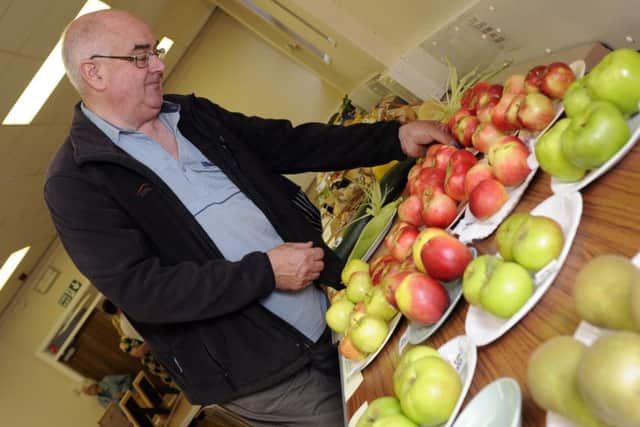 Edward Thompson lays out some of his fruit he has grown.
