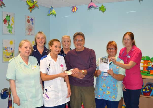 Ian Cross (centre) and the staff from the childrens ward.