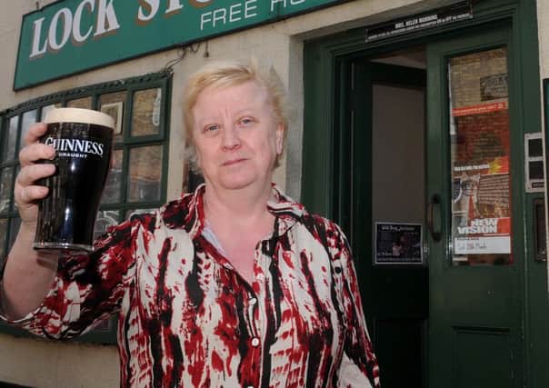 Helen Manning, landlady of the Lock, Stock and Barrell Free House, Crowle holds up a pint of Guinness which will be free as part of an offer. Picture: Andrew Roe