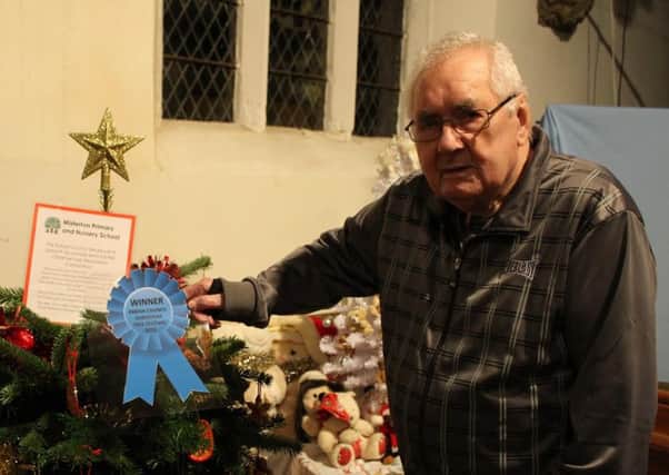 Sid Burgess with the winning Christmas tree by pupils from Misterton Primary and Nursery School.
