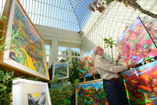 5 Sept 2105.....Artist David Brightmore with some of his paintings in one of the glasshouses in Sheffield's Botanical Gardens as part of the Art in the Gardens event. Picture Scott Merrylees SM1009/37b