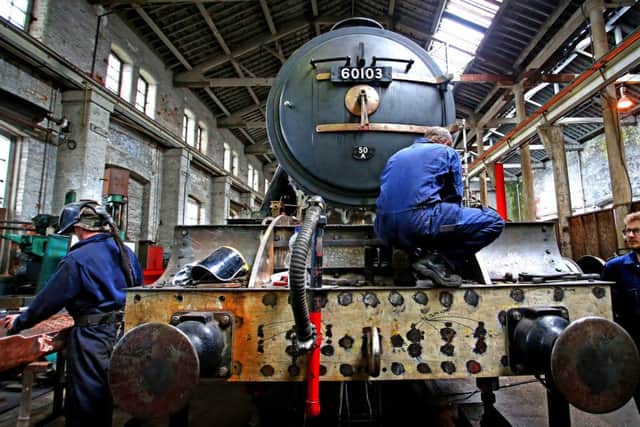Colin Green (centre) co-director of Riley & Son Ltd in Bury, working on the restoration on the Flying Scotsman