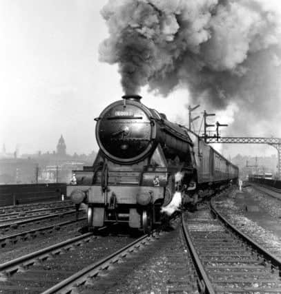 Flying Scotsman' A3 Class steam locomotive leaving Leeds station, Yorksire, with the 'White Rose' express for King's Cross station. Photograph by Bishop Eric Treacy (1907-1978) who was often allowed special access to many areas denied to other railway photographers.