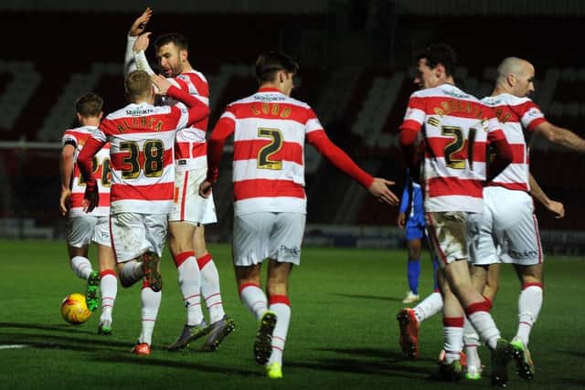 Doncaster's players celebrate Andy Williams' late goal