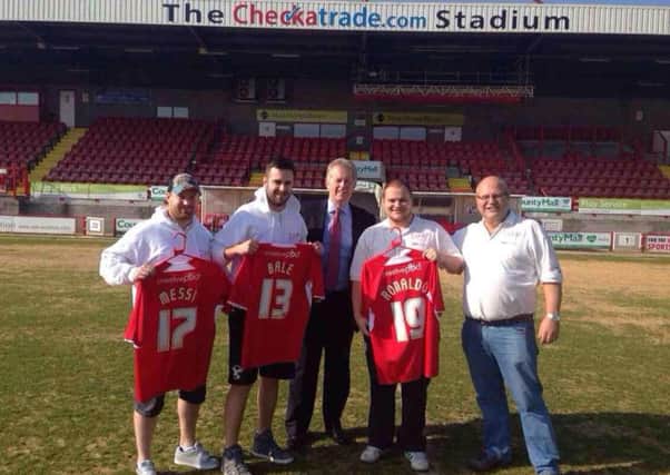 At Crawley, where the team got invited onto the pitch for a photo and presented with team shirts to auction.