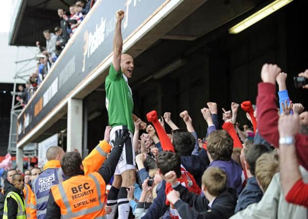 Rob Jones celebrates winning the League One title in 2013.