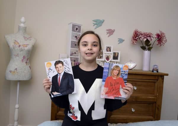 Paris Mullholland in her newly decorated bedroom in Doncaster with her signed pictures from Good Morning Britain presenters