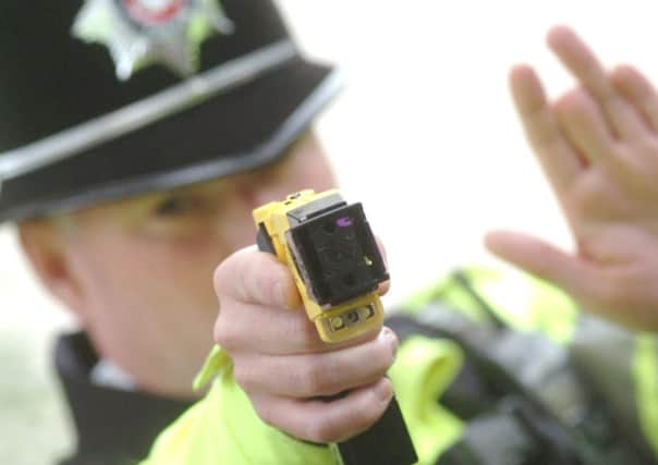 A police officer with a taser gun