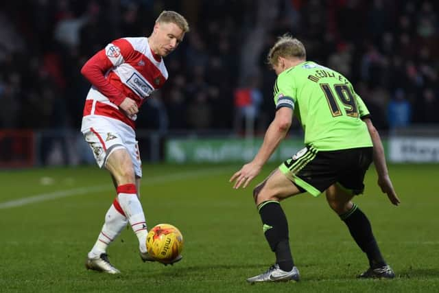 Rovers' Craig Alcock up against United's Jay McEveley