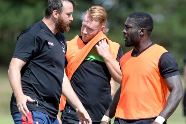Paul Cooke (left), pictured talking to Tyson Lewis in training.