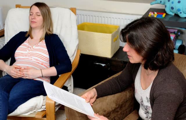 Lucy Atkinson relaxes Hannah Parker during her hypnobirthing class. Picture: Andrew Roe