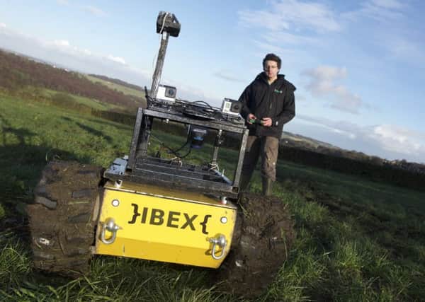 Dr Charles Fox and his weed-busting IBEX robot on farmland at Green Moor