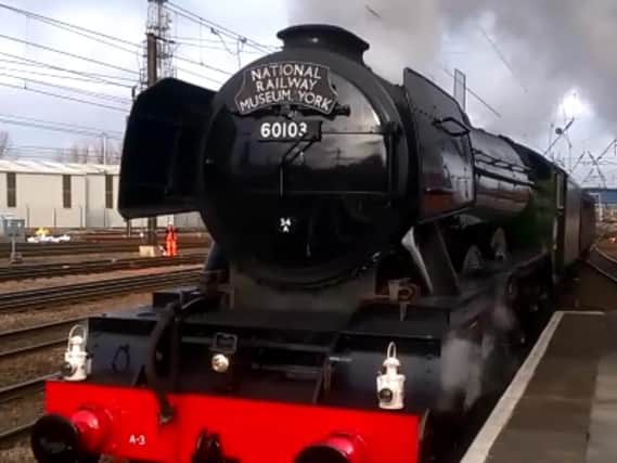 The Flying Scotsman steams through Doncaster en route to London yesterday.