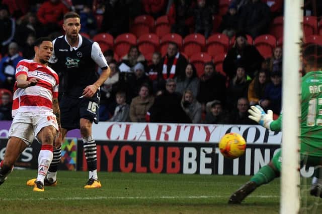 Nathan Tyson has his shot saved by Millwall's keeper Jordan Archer