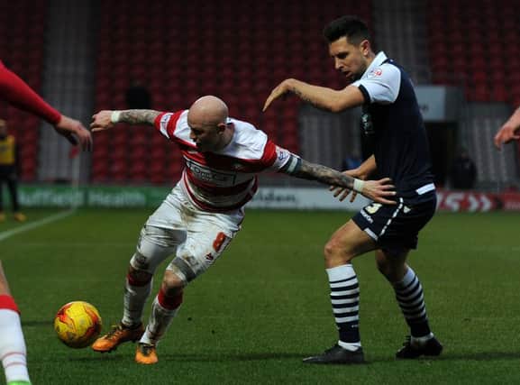 Doncaster's Richard Chaplow fends off Millwall's Lee Gregory