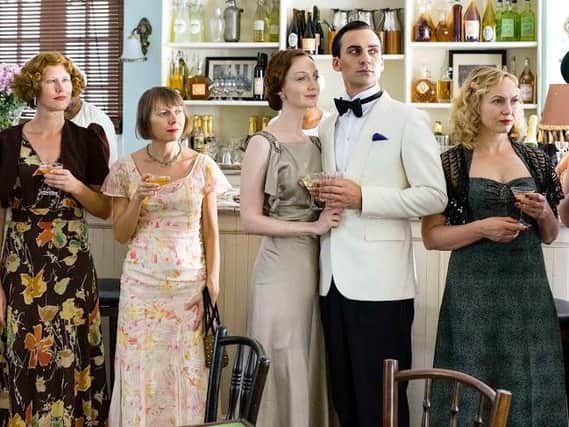 (Olivia Grant) and Ralph (Henry Lloyd-Hughes) with other guests.