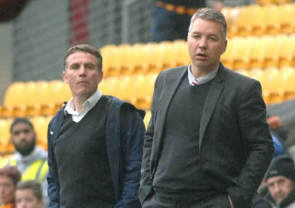 Darren Ferguson watches his team come unstuck at Bradford City, alongside Bantams boss Phil Parkinson.