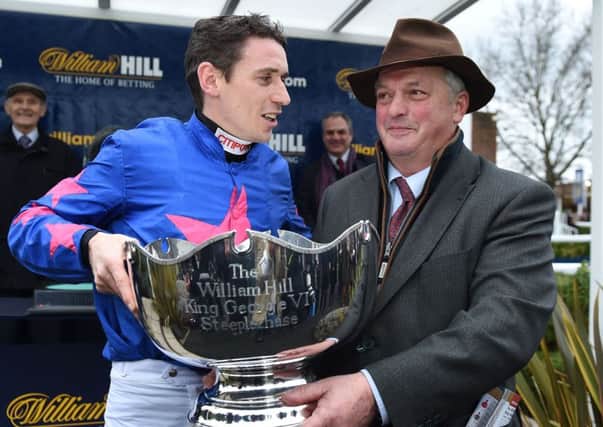 Jockey Paddy Brennan (left) and trainer Colin Tizzard celebrate  winning the King George VI Steeple Chase with Cue Card  at Kempton - and hope to land the  Timico Cheltenham Gold Cup on Friday.   Photo: Andrew Matthews/PA Wire