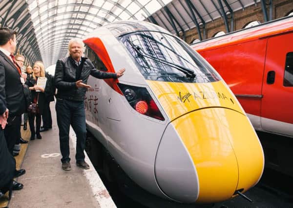 Handout photo issued by Virgin Trains of Sir Richard Branson unveiling the Virgin Azuma, the first of their new fleet which will cut journey times on the East Coast Main Line by up to 22 minutes, at King's Cross station in London.