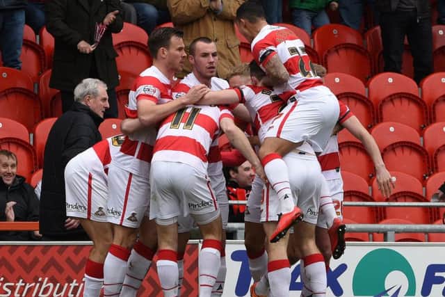 Doncaster's players celebrate James Coppinger's goal