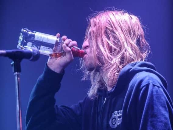 Wes Scantlin swigs a bottle of Southern Comfort on stage at Diamond Live Lounge. (Photo: Robin Burns).