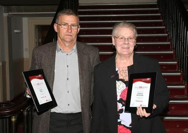 Jim Rust and Christine Wooldridge receive their awards for reaching 100 blood donations each.