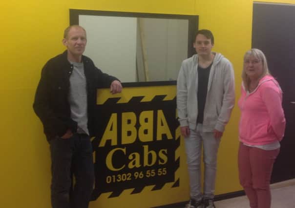 Abba Cabs has opened a new town centre office. Left to right are owners David lilley and Ryan Waugh and driver Marie Stevens.