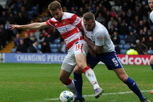 Andy Williams holds off Bury's Peter Clarke