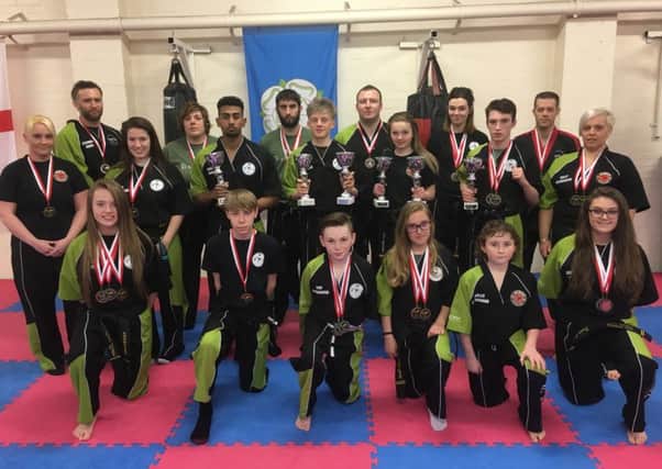 Members of Andy Crittenden's Martial Arts Centre show off their medals.
