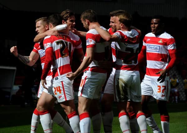 Doncaster's players celebrate Tommy Rowe's goal