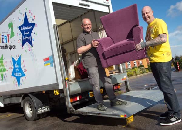 Rotherham Hospice delivery drivers Mark Thompson and Mark Jones loading one of the vans they use to collect and distribute items to the shops