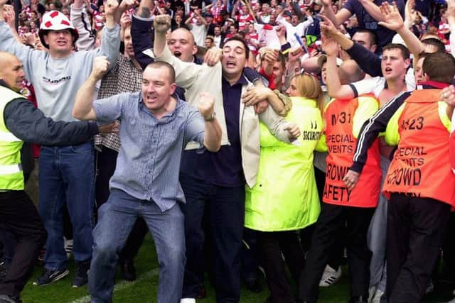 Rovers fans start the party on the pitch at the Britannia Stadium.