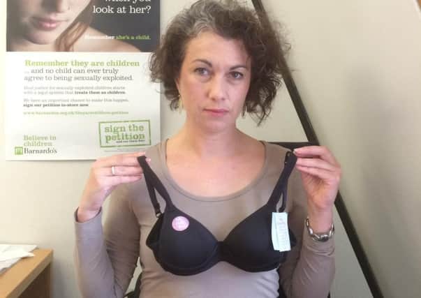 Sarah Champion MP with the children's bra which she says is "too sexualised."