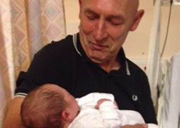 Steve Fennell, aged 56, of Balby, Doncaster, holds his baby grandson Mason. Steve died of cancer shortly after in May 2015.