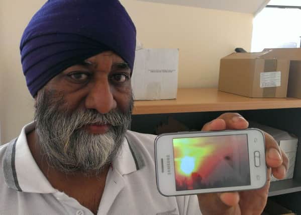Jarnel Singh, of Balby, with the picture he thinks is a UFO over Balby
