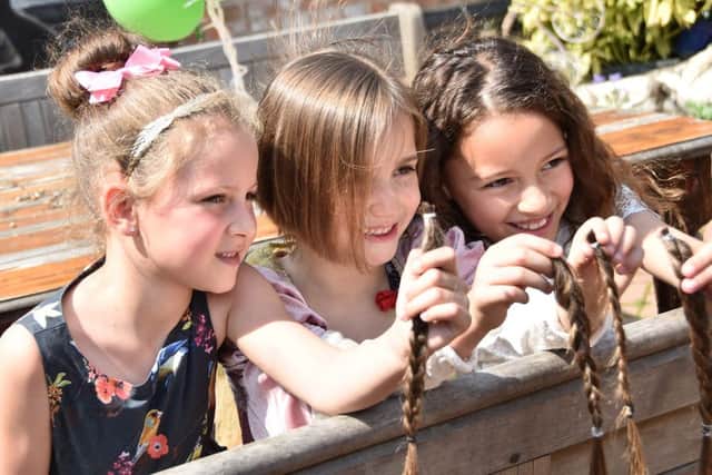 Five-year-old Sophia Gilchrist-Thomas (middle) is set to raise up to Â£1,000 for Bluebell Wood Children's Hospice after she cut off her hair for charity.