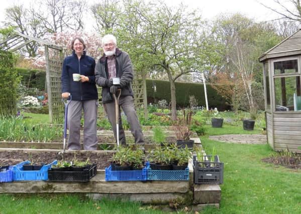 Tricia and Alistair Fraser in their garden