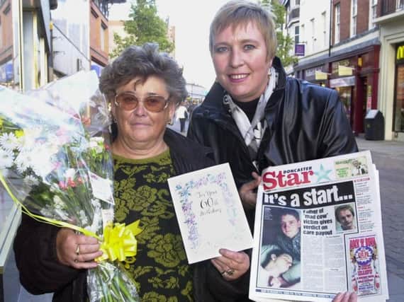 Josie Williams (left) is presented with gifts on her 60th birthday.
