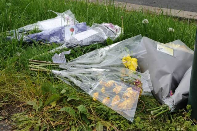 Floral tributes have been left on Braemoor Road at the junction with Wadsley Lane for Matthew Wilson, who was stabbed. Picture: Andrew Roe