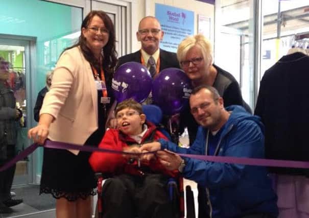 Kian cuts the ribbon to open the Doncaster charity shop. L to r:- Joanne Ward, retail support co-ordinator, Kian Critchley, James Bower, head of retail, Karen Williams, doncaster shop manager and Tony Critchley, Kians dad.