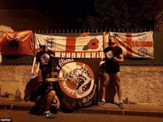 The Russian fans with their stolen Wednesday flag. (Photo: Twitter)