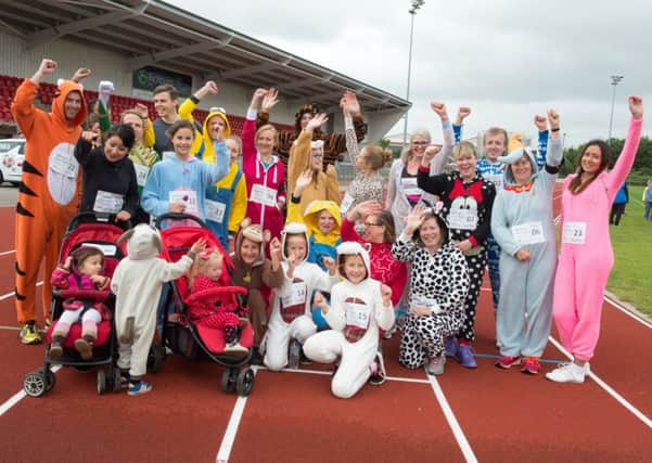 The Onsie Fun Run gets underway at the Keepmoat Stadium Athletics track in Doncaster