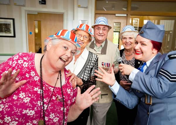 Having fun are residents of Roman Ridge, Shiregreen as they celebrated Armed Forces Day. Pictured are from the left, are residents Gillian Oakley, Jean Ellerton, Jock Sturrock and Pearl Hirst. They are pictured with Razzle Dazzle performer Claire Hudspeth.