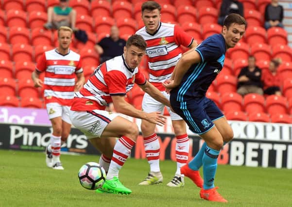 Tommy Rowe for Doncaster and Stewart Downing for Middlesbrough. Photo: Chris Etchells