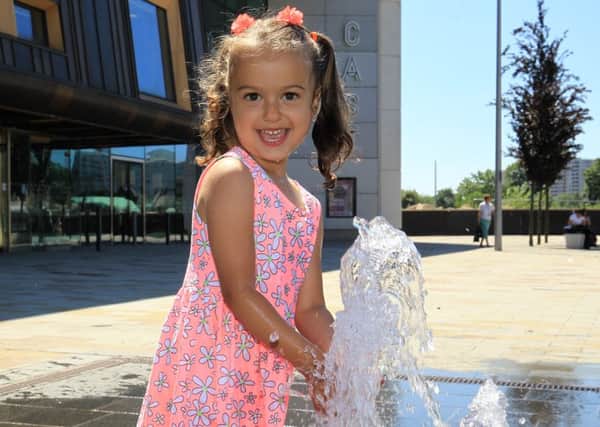 Fun in the sun at Sir Nigel Gresley Square in Doncaster. Sobhia Kornejeva, three, having fun in the water fountain.