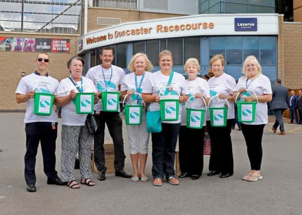The volunteers and hospice appeal staff are pictured at Doncaster racecourse just before the collection started.