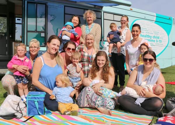 Natalie Cocksworth is pictured second from the right, together with Paula Cafferty, of RDaSH, centre (fifth from the left), surrounded by Doncaster mums and their babies and toddlers