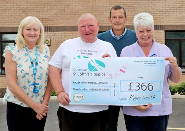 Roger Smith is pictured (second from the left) surrounded by staff from the hospice and hospice appeal